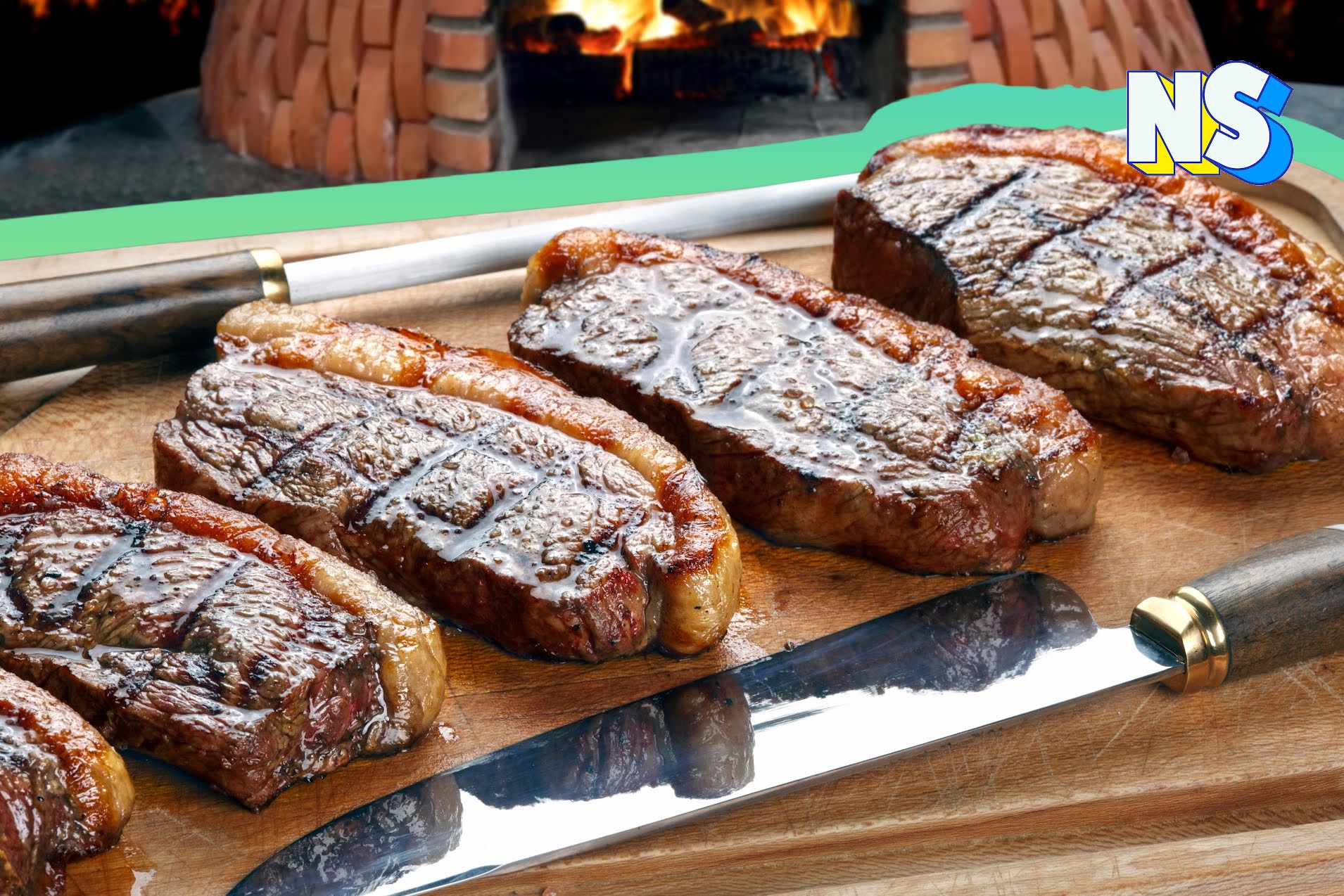 Churrasco meat on a cutting board next to a knife